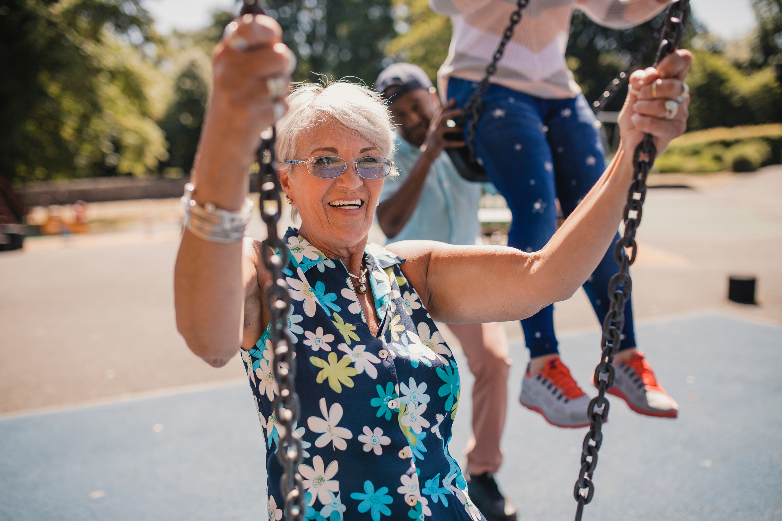 Senior Women Being Pushed on Children's Swings